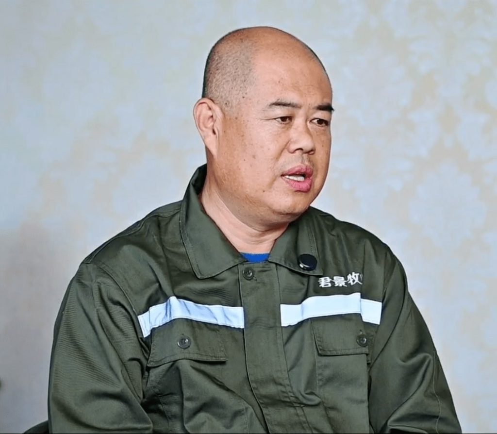 Closeup of a man wearing a green overall